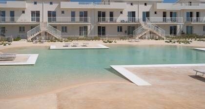 GuestHost - Charming 75 sqm seaview apartment on two levels, for 5 people, located inside the renowned Borgo 84 residence, equipped with swimming pool and cycle path. The property is located just 3 km from the center of Marzamemi, one of the most fascina