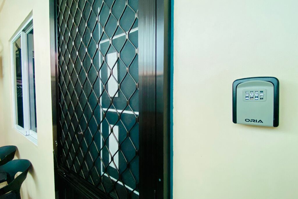 A security keypad and a metal gate with a diamond pattern.