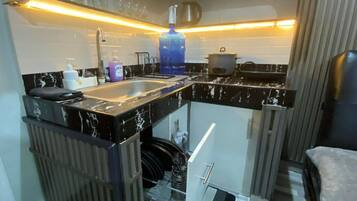 Fridge, stovetop, electric kettle, cookware/dishes/utensils