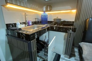 Fridge, stovetop, electric kettle, cookware/dishes/utensils - 2BR at Amplayo Apartelle — Modern comfort, cozy vibes at an affordable price... (Cagayan de Oro City)