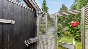 A black wooden gate with a metal latch and a small metal box attached to the wall. - Cozy home in Vejby with sauna (Vejby)