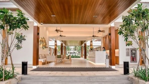 A spacious lobby with a wooden ceiling, a reception desk, and seating area. - BIG SALE | Full equipment apartment | Pool & beach (Đà Nẵng)