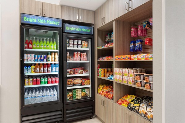 Dos dispensadores refrigerados de bebidas con productos varios, identificados como "Bright Side Market".