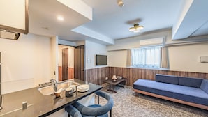 A modern hotel room with a kitchenette, a sofa, a dining table, and a large window with curtains. - Apartment Hotel 11 Abeno (Osaka)