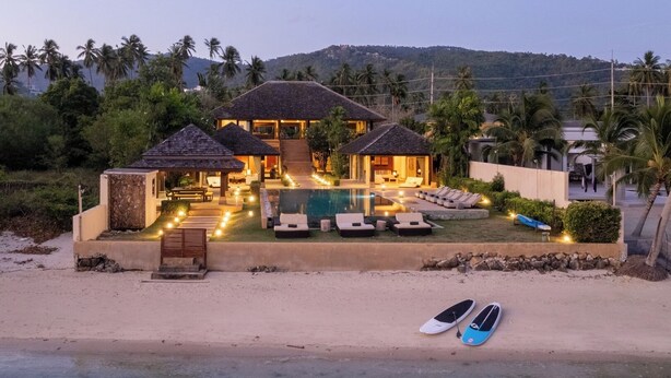 A beachfront resort with a swimming pool, lounge chairs, and a beachside view. - Villa Sai Tai – A Private Haven on the Edge of Paradise (Thong Krut)