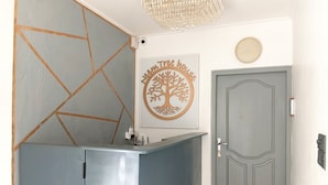 A reception desk with a wall-mounted clock and a framed tree logo.