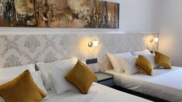 Deluxe Quadruple Room, City View | Premium bedding, down duvets, pillow-top beds, in-room safe
