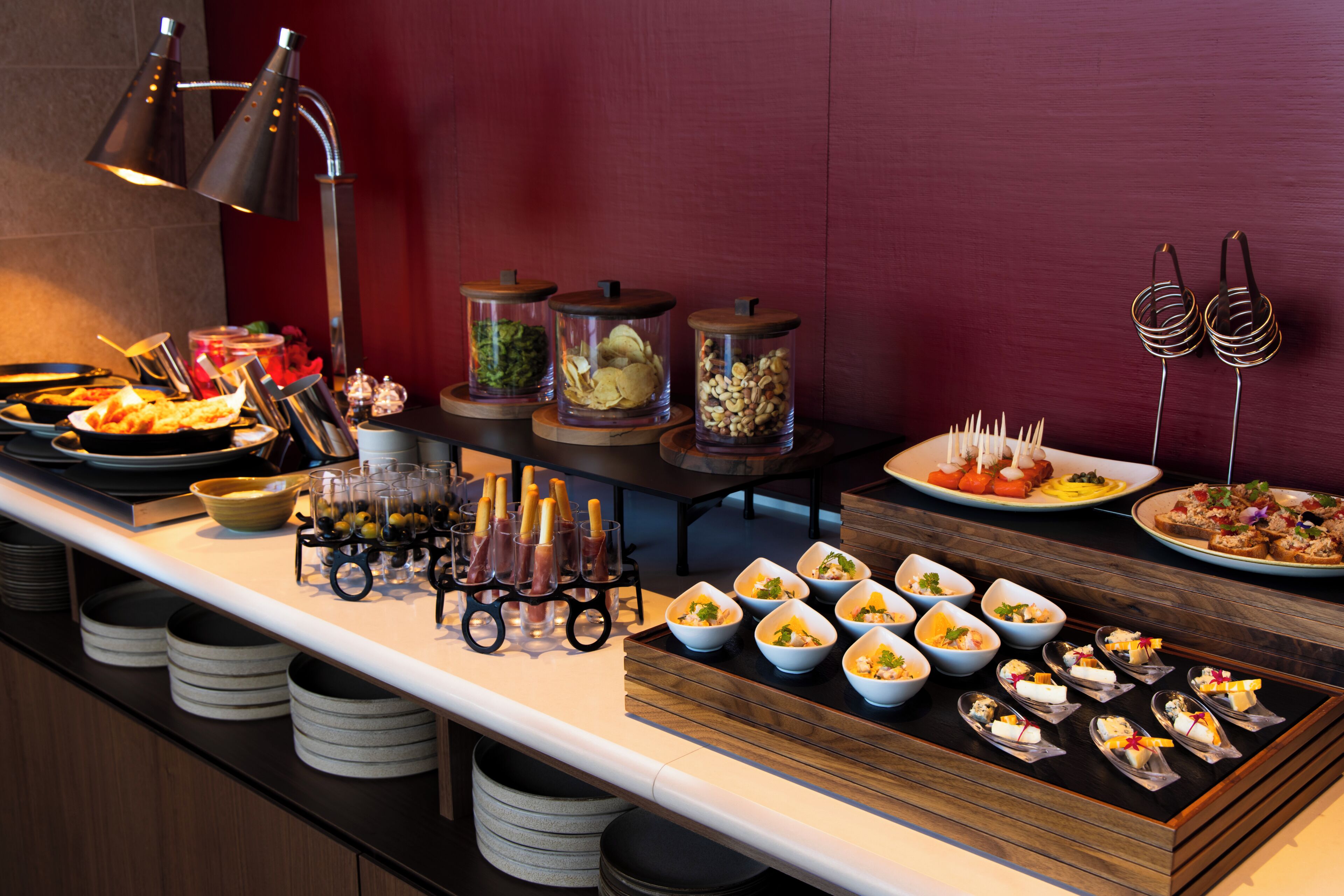 A buffet setup with various food items and containers.