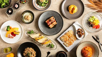 A variety of dishes including tacos, rice, and a dessert on a table.