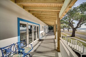 Relax in a serene outdoor space with comfortable seating and a view of the ocean.