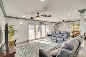 Relax in this inviting living area with a large sofa, armchair, and flat-screen TV.