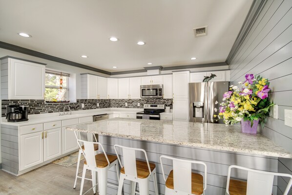 Enjoy cooking in this well-equipped kitchen with a large island and bar stools.