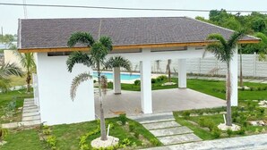A white building with a tiled roof and a covered patio area. - Comfort & Privacy:Family, Couple - rent Villa in Punta Cana with A/C, WIFI, POOL (Punta Cana)