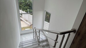A modern staircase with metal railings and a view of a paved area outside. - Comfort & Privacy:Family, Couple - rent Villa in Punta Cana with A/C, WIFI, POOL (Punta Cana)