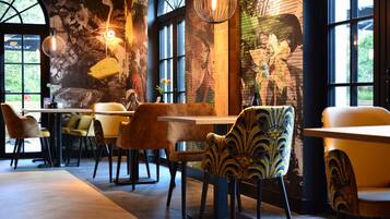 Enjoy dining and socializing in this stylish space with large windows and vibrant murals.