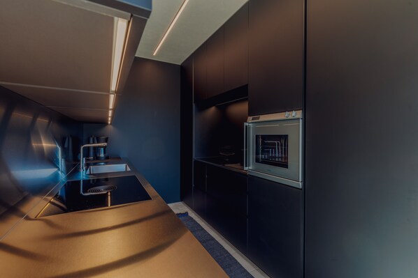 A modern kitchen with a built-in oven and a sleek countertop.