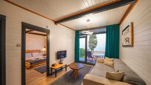 A modern hotel room with a wooden ceiling, a sofa, a TV, and a balcony with a view. - SAPANCA KIYI BUNGALOV (Sapanca)
