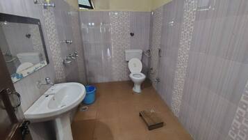 A bathroom with a sink, toilet, and shower.