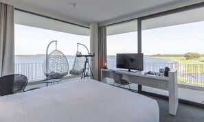 Enjoy a scenic view of the water and greenery from the balcony, where you can relax in one of two unique chairs.