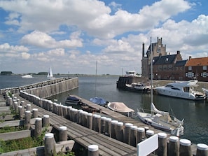 Guests can enjoy waterfront views from the dock, where sailboats and yachts are moored.