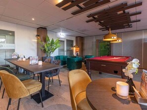Relax in style with a pool table, billiards table, and plush seating area.
