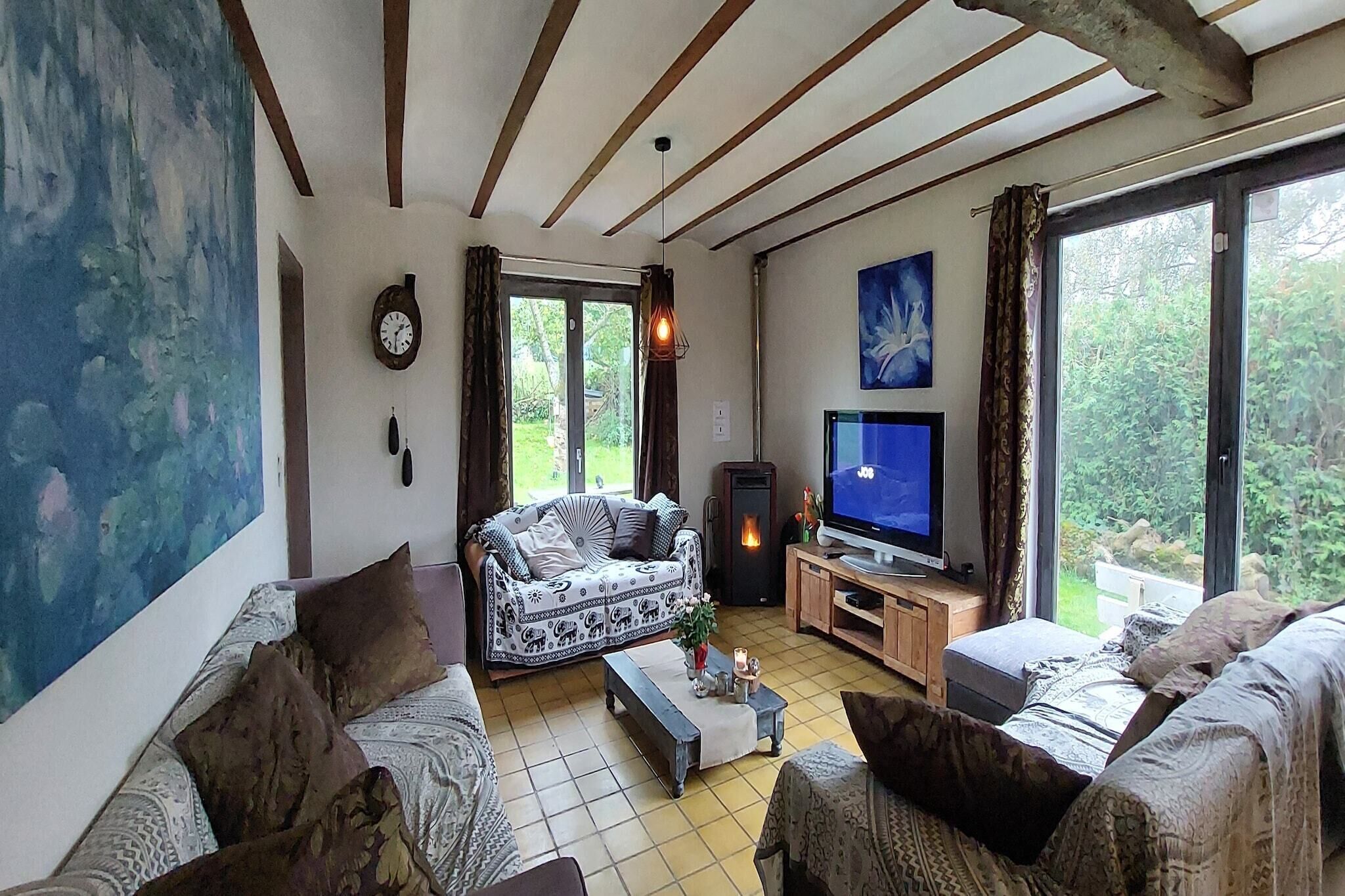 A cozy living room with a sofa, a television, and a fireplace.