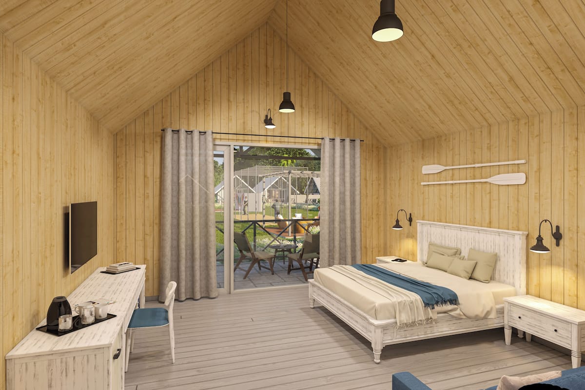 Een slaapkamer met houten lambrisering, een bed, nachtkastjes, een bureau en een stoel.