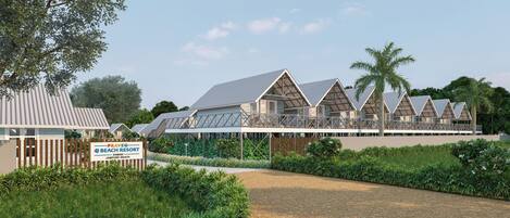 A resort with multiple bungalow-style buildings, a well-maintained garden, and a clear sky.