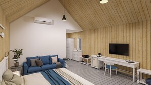 Ein moderner, gut beleuchteter Raum mit Holzbalkendecke, einem Bett, einem Sofa, einem Schreibtisch und einem Fernseher.