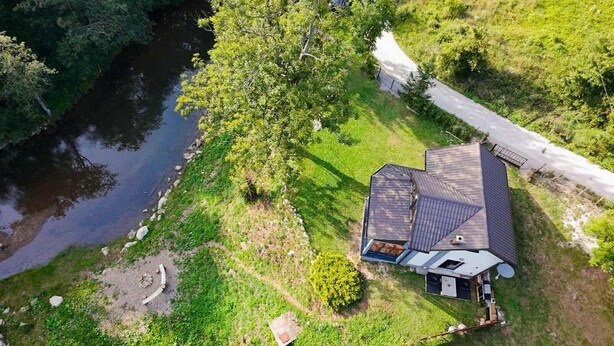 A house with a large deck, a satellite dish, and a pond. - Funky House Sarajevo (Ilovice)