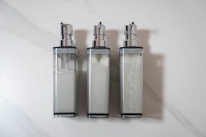 Three bottles of clear liquid on a white surface. - PRALINE (Sapporo)