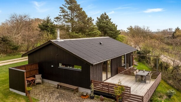 A modern house with a large deck, a covered patio, and a fenced garden area. - "Lenya" - 300m to the fjord by Interhome (Struer)