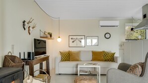 A cozy living room with a fireplace, a sofa, a coffee table, and a TV. - "Lenya" - 300m to the fjord by Interhome (Struer)