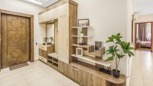 A modern interior with a wooden door, built-in shelving, and a potted plant. - Stay Inn on Aram street (Yerevan)