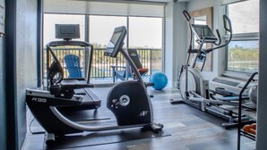 A gym with cardio equipment, a rowing machine, and a stationary bike. - 901A Beachfront Heated Pool Studio Harborside View (Galveston)