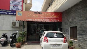 A hotel entrance with a sign reading "Hotel Raj Mahal Welcomes You".