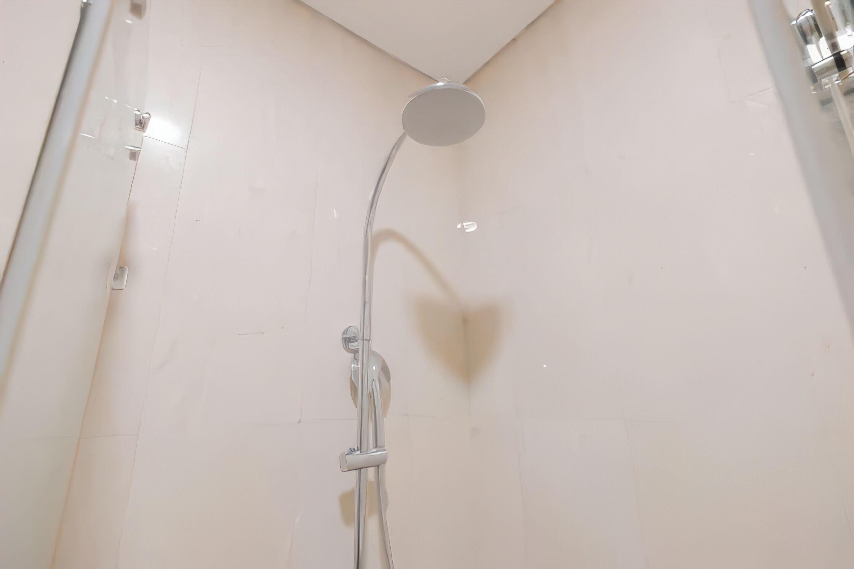 A shower with a round head and a single-handle control.
