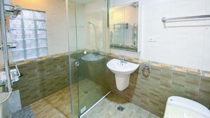 A modern bathroom with a glass-enclosed shower, a sink, and a toilet. - Eco Nest Apartment & Stay (Hanoi)