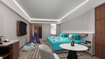 Relax in a stylishly designed room with a comfortable bed, sofa, and armchairs.