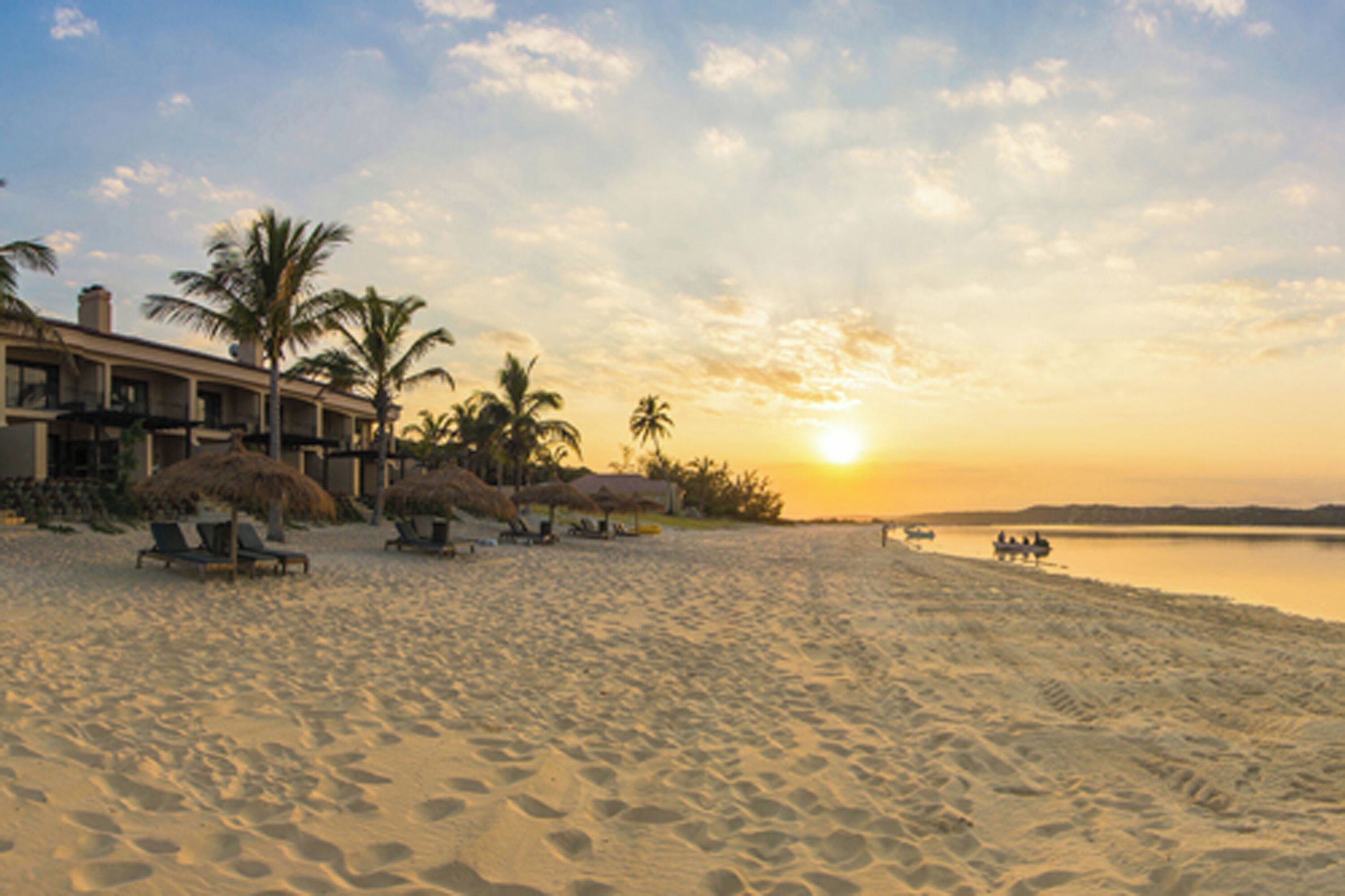 On the beach, white sand, sun-loungers