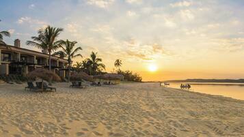 On the beach, white sand, sun-loungers