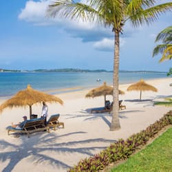 On the beach, white sand, sun-loungers