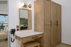 Ein Badezimmer mit einem Holzkosmetikschrank, einem Spiegel und einer Wandleuchte.