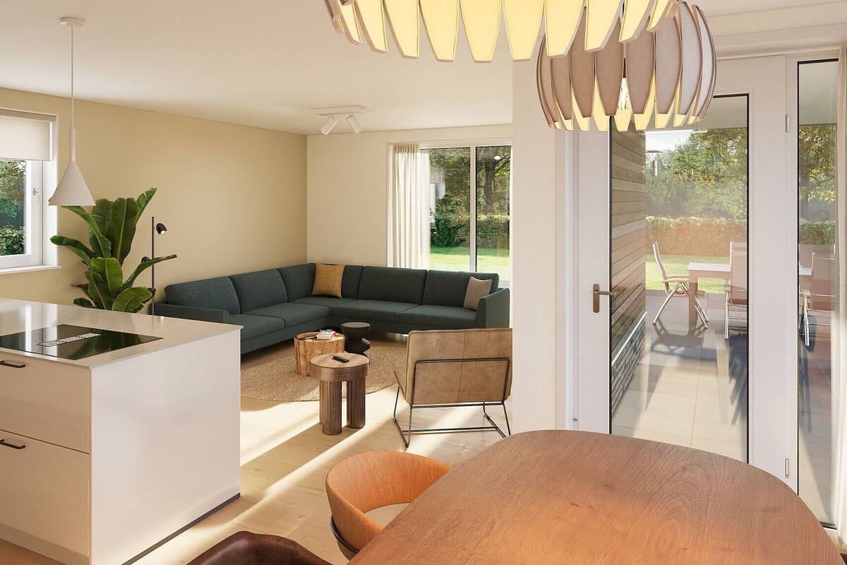 Una cocina moderna con una isla integrada, un comedor con mesa redonda y una sala de estar con sofá seccional.