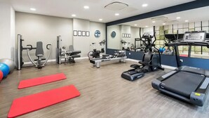 A gym with cardio equipment, weight machines, and red mats. - Student Only Knoll Court (Newcastle-upon-Tyne)