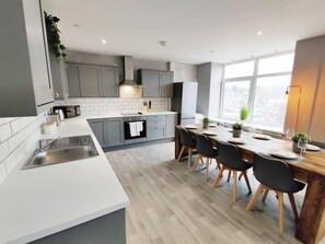 Enjoy meal preparation and dining in this well-equipped kitchen with a sink, central island oven, and ample counter space.