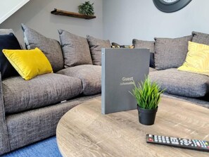 Relax in this stylish living room with a sofa, coffee table, and potted plant.