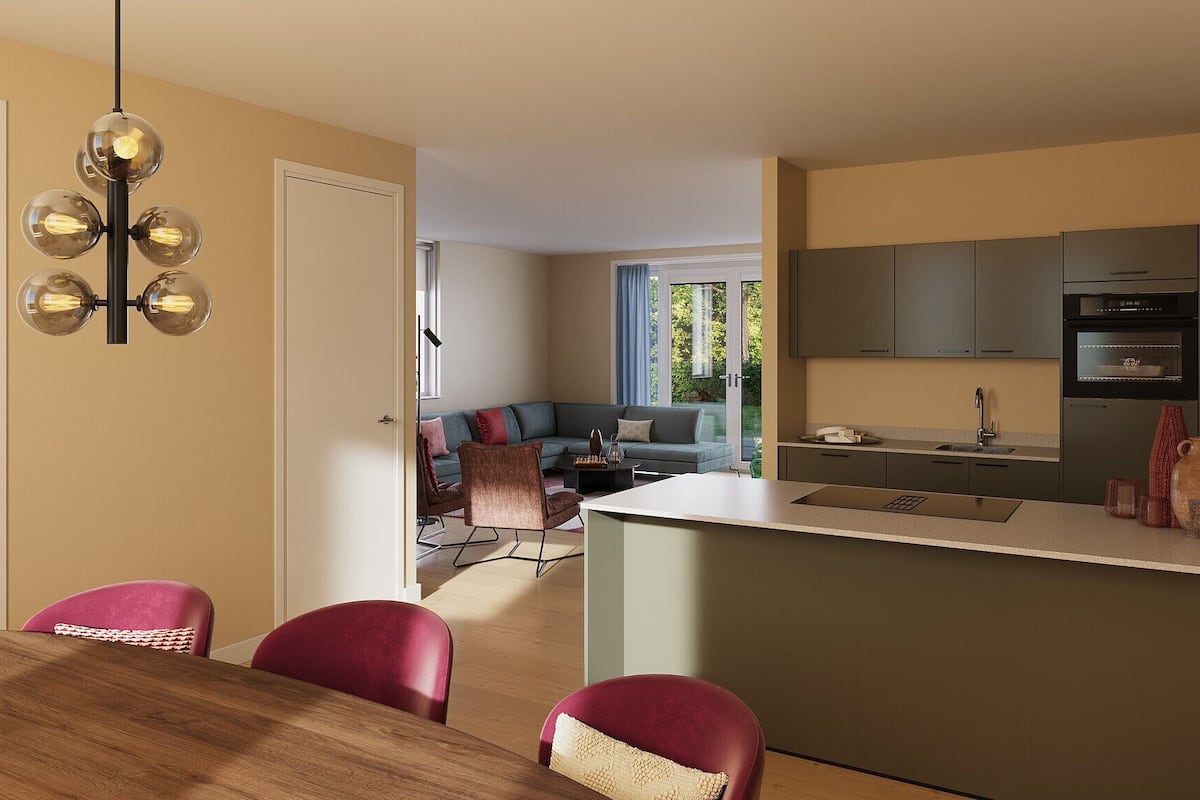 A modern kitchen with a built-in oven and a dining area with a wooden table and red chairs.