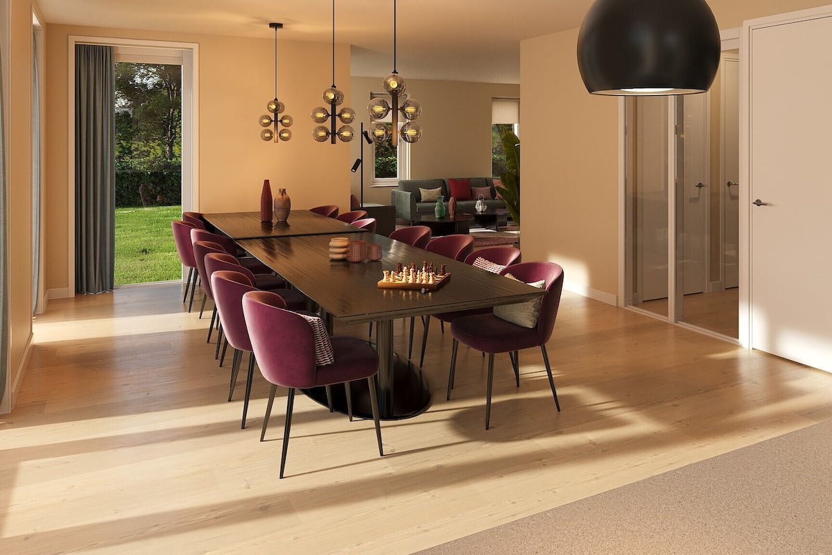 A modern dining area with a long table, multiple chairs, and a chessboard.