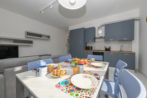 A modern kitchen with grey cabinets, a microwave, and a sink. - MGH- My Desenzano Center Apartment (Desenzano del Garda)